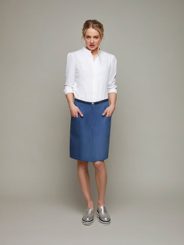 Front view of STRATUS multi-way rain jacket in Marine blue as a skirt, available from British sustainable fashion brand DEPLOY