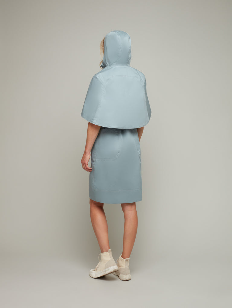 Back view of SEASON multi-way trench coat with cape in fog blue, available from British sustainable fashion brand DEPLOY