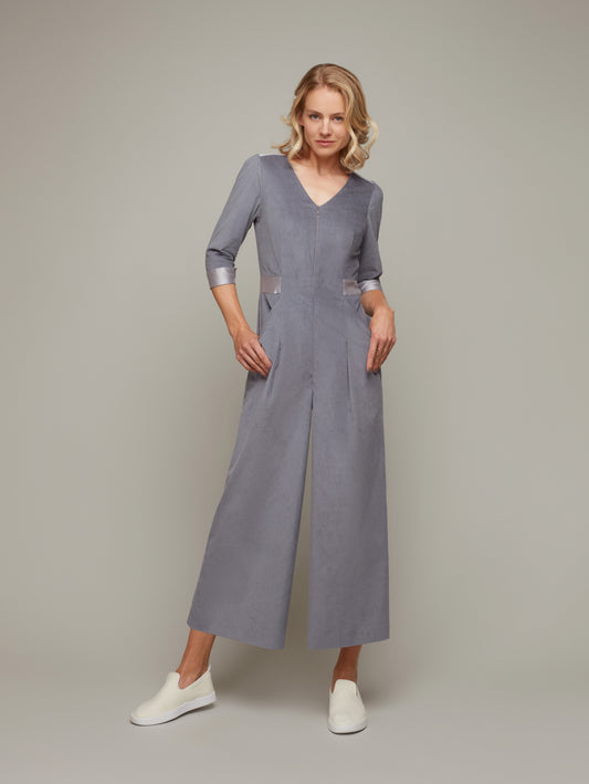 Front view of COLONNADE tailored 3/4 sleeve jumpsuit in Frost Grey with sneakers, available from British sustainable fashion brand DEPLOY