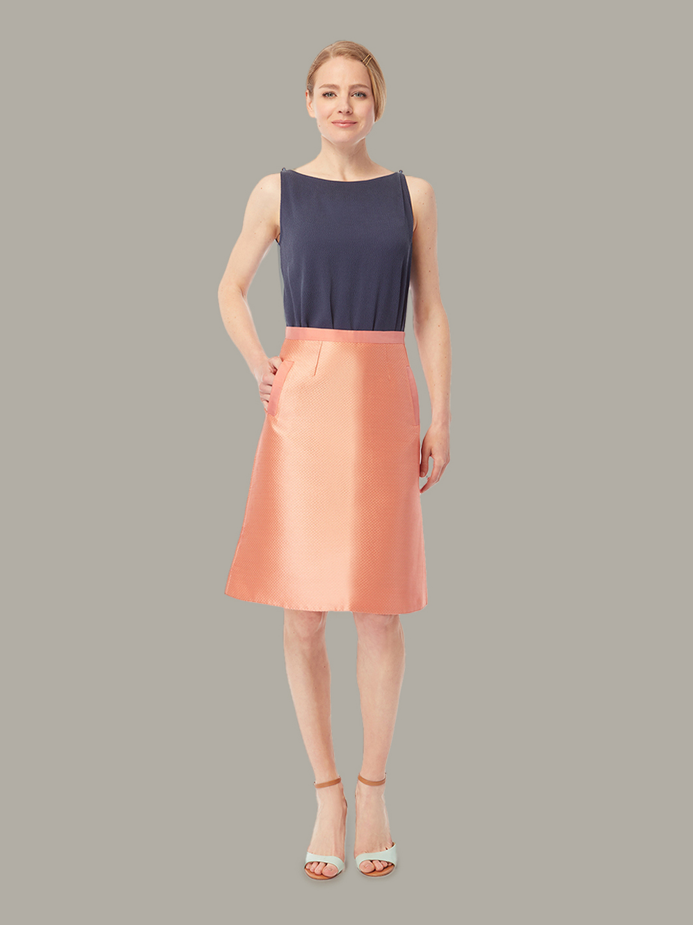 Front view of high-waist a-line skirt in peach blush, available from British sustainable fashion brand DEPLOY